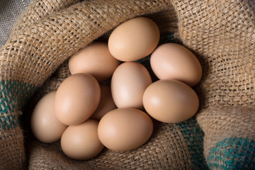 Fresh eggs from a farm in a bag. Top view. Crude products.