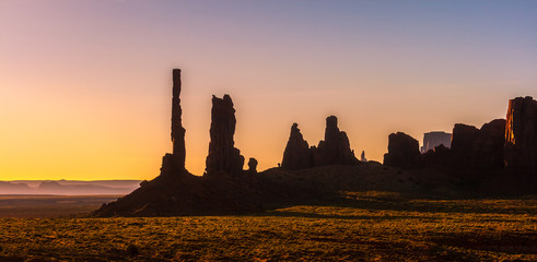 Monument Valley scenery at sunrise. Totem Pole and Yei Bi Chei rocky spires landscape. Monument Valley Navajo Tribal Park, USA.