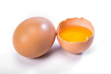 Cracked and whole chicken eggs on white background. Closeup, organic eggs