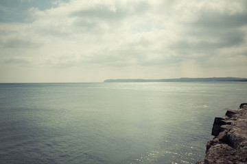 sea ​​landscape in the rays of the sun coming out from behind the clouds