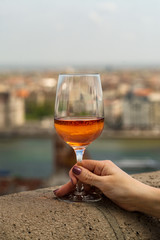 a glass of wine in hand