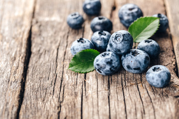 Freshly picked blueberries on wooden background. Healthy eating and nutrition.