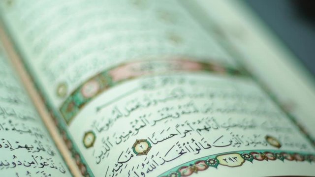 the holy Quran muslim holy book, detail of surah al kahf in slow motion 