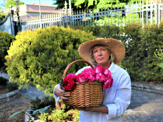 blurry portrait middle aged woman with a bouquet of roses