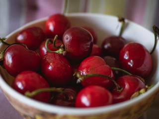 Red cherries in a bowl close-up