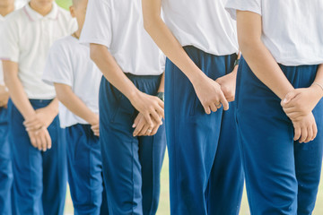 Group of students try to meditate for the peace of mind by walk with Buddhist monk in school.