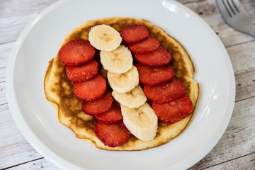 Strawberry Banana Crepe on wooden background