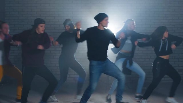 Six Caucasian rappers perform in the night competition for street dance. Unforgettable presentation