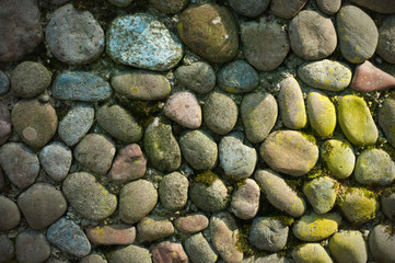 Sea stones background. Rounded stones texture. Colored cobblestone