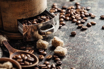 Coffee with coffee grinder and coffee beans on dark textured background.
