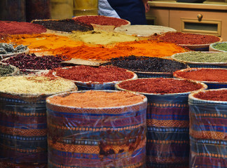 Multiple spices in colorful containers in Istanbul, Turkey market.