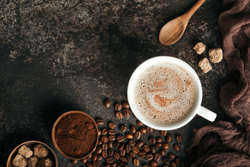 Coffee board with coffee beans on dark textured background.