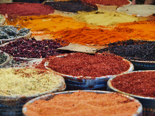 Multiple spices in colorful containers in Istanbul, Turkey market.