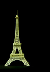 Fototapeta na wymiar A model Eiffel tower of cardboard isolated on black