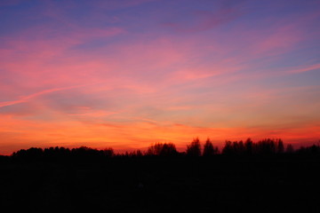 Fototapeta na wymiar sunset over green field