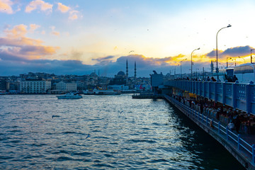 Fishermen are on the Galata Bridge, and people walk on the Galata bridge in summer, Istanbul, Turkey, 12.01.2019