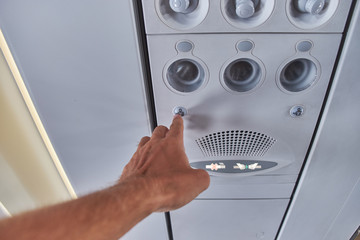 Flight attendant call button. Air conditioning in the plane