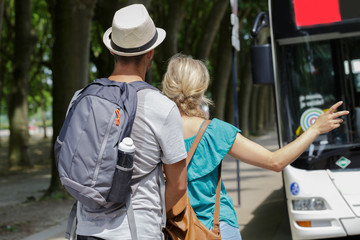 young couple getting into bus