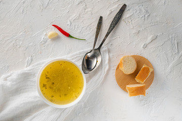 home cooked boullion or clear soup in a ceramic bowl at the kitchen, healthy food and diets