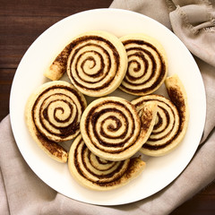 Homemade cocoa rolls or buns made of yeast dough and filled with sugar and cocoa powder, photographed overhead with natural light