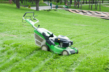 lawn mower on green grass in the park