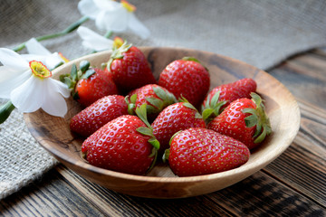 Fresh strawberries in a wooden bowl