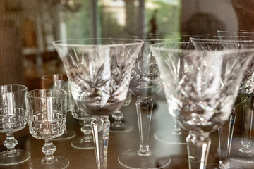 old vintage glasses for cocktail and wine in a wooden showcase in the living room