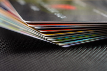 Credit cards are displayed by a fan on a black background.