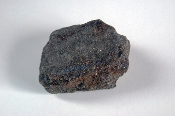 Chalcopyrite specimen in rock on a gray background. Origin: Altai.