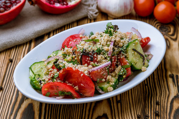 vegetable salad with nuts on wooden background
