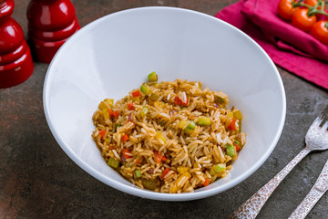 Rice with vegetables on white plate