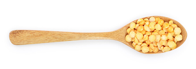 yellow split peas in a wooden spoon isolated on white background. Top view
