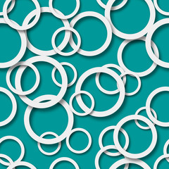 Abstract seamless pattern of randomly arranged white rings with soft shadows on light blue background