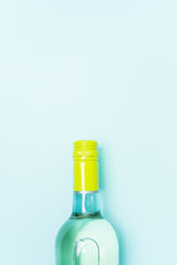 Screw bottle foil caps in different bright colors of white and rose wine bottles on blue background with copy space. Minimal abstract colorful mockup concept of alcohol beverage. Flat lay.