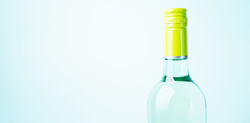 Screw bottle foil caps in different bright colors of white and rose wine bottles on blue background with copy space. Minimal abstract colorful mockup concept of alcohol beverage. Flat lay.