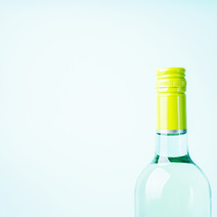 Screw bottle foil caps in different bright colors of white and rose wine bottles on blue background with copy space. Minimal abstract colorful mockup concept of alcohol beverage. Flat lay.