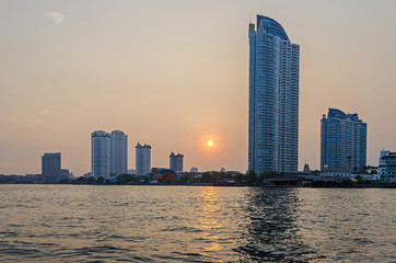 Fototapeta na wymiar Skyline of Bangkok at the banks of the Chao Phraya River at sunset