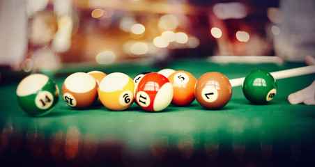 Colorful billiard balls on a billiard table.