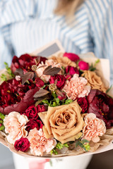 Beautiful bouquet of mixed flowers in woman hand. Floral shop concept . Beautiful fresh cut bouquet. Flowers delivery