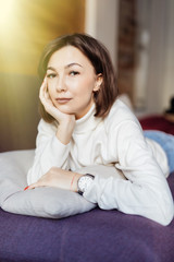 beautiful young woman lying relaxing on the couch, sofa home indoors