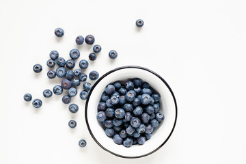 Blueberries in bowl isolated on white background, table top view