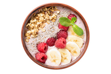 Pink smoothie bowl with fruits, granola, chia seeds isolated on white background, table top view