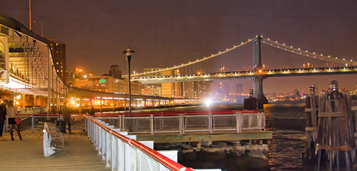 Fototapeta na wymiar Pier 17 in new York City at night with city skyline view