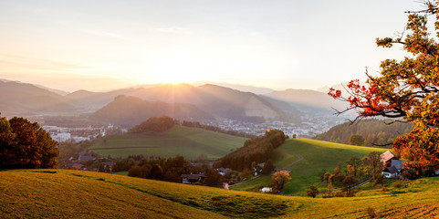 autumn sunset panorama in the austrian alps shining at an alpine meadow at the mountains in styria