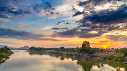 Fotobehang Mekong River Pakse Laos sunset dramatic sky reflection on water village on riverbank travel destination in South East Asia © fabio lamanna
