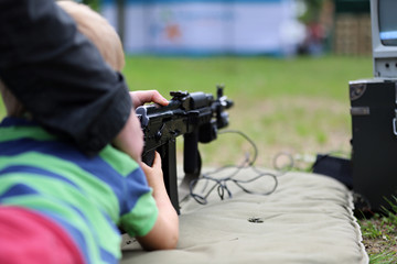 boy shooting from a pneumatic rifle