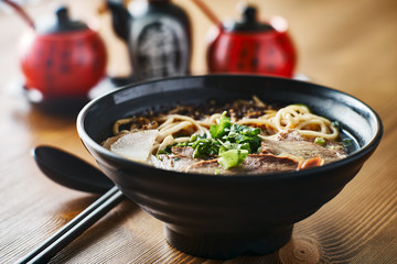 bowl of chinese beef soup on table