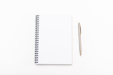 blank sheet of notebook with a spiral and pen on a white background. Copy space.