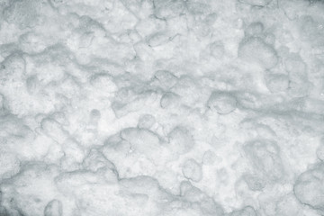 Natural winter background with snow drifts and falling snow