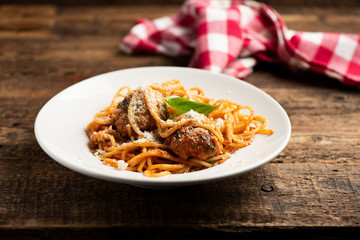Beef meatballs with bolognese sauce and spaghetti.